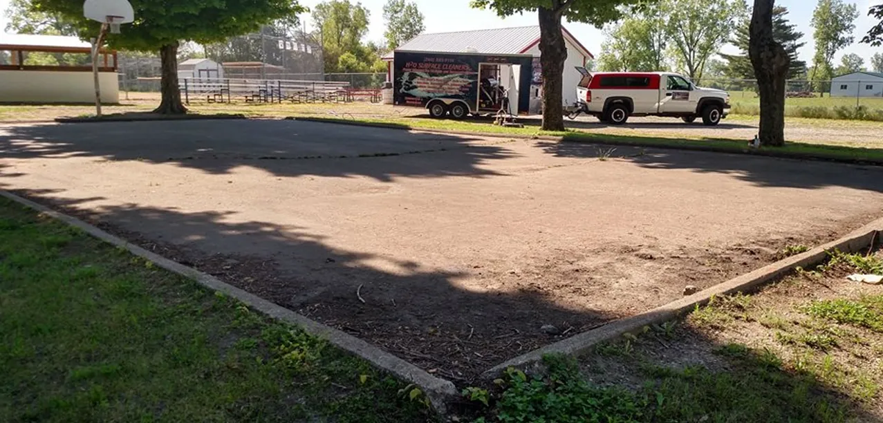 Concrete pad with the H2O truck and trailer parked behind it