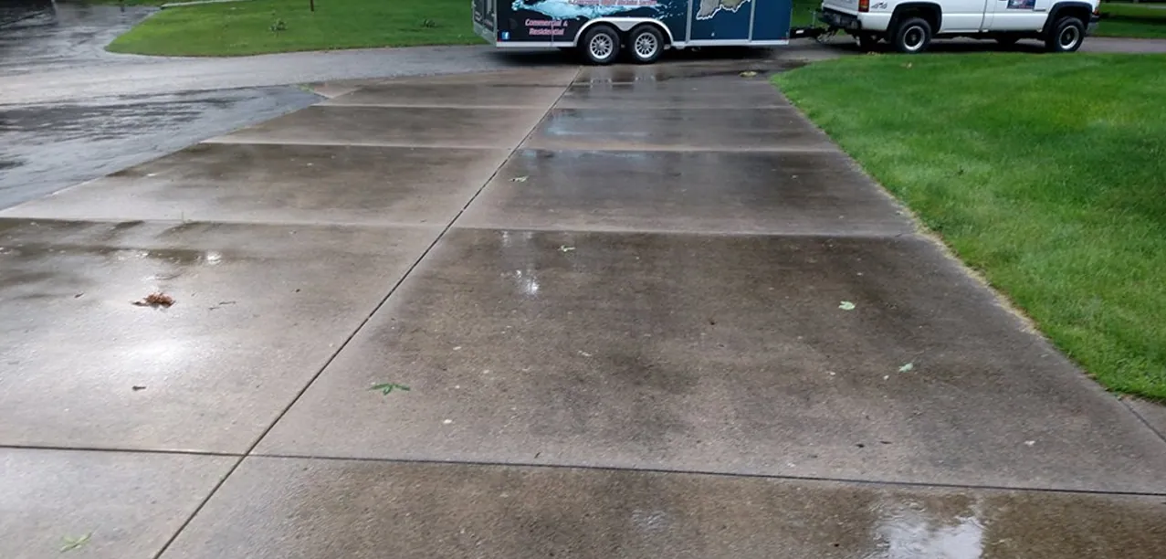 Freshly washed concrete driveway with the H2O trailer at the far end