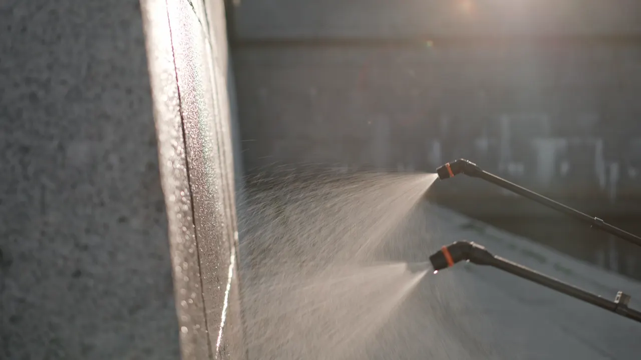 Crew pressure washing a commercial parking lot