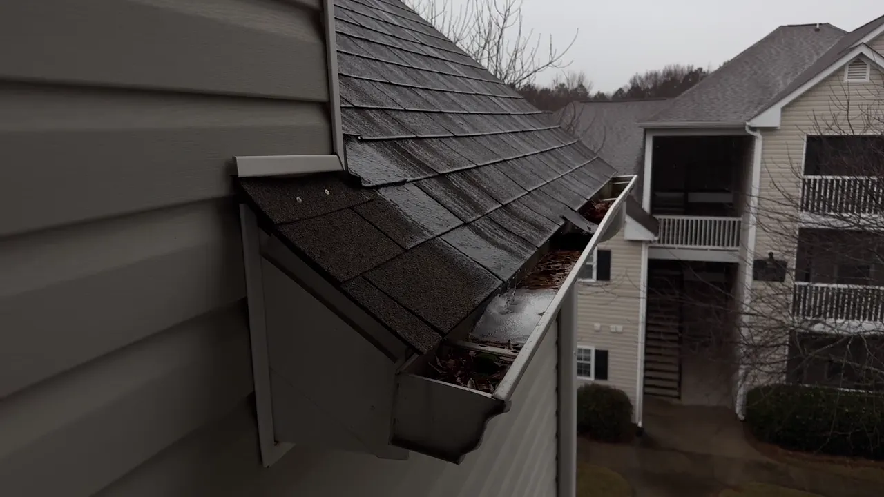 Gutter along a shingle roof edge